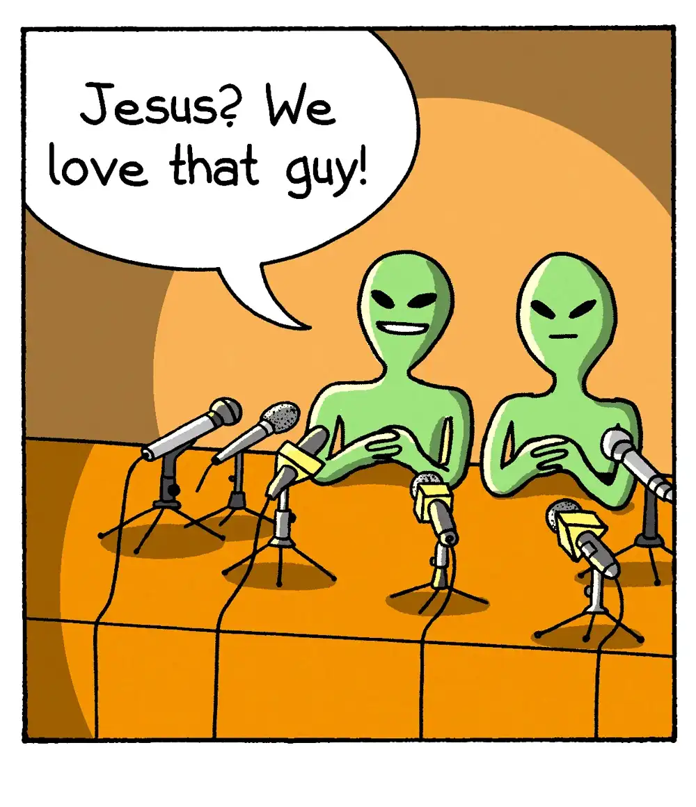 Two green alien figures sit at a press conference table with multiple microphones in front of them. One alien speaks through…