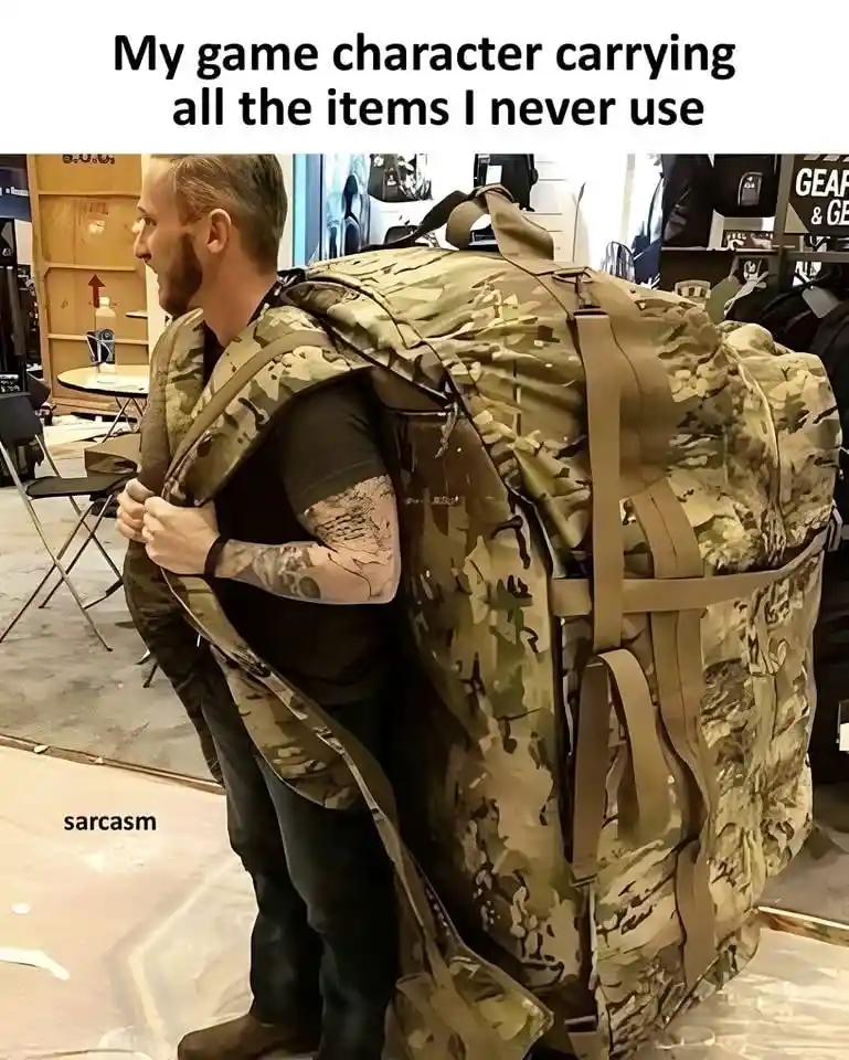 A man with a tattooed arm stands in what appears to be a gear store, wearing an enormous, bulky camouflage backpack that is…