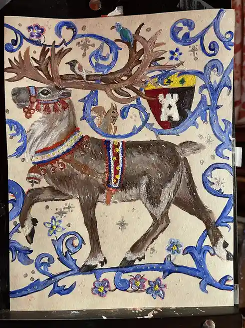 A hand-painted artwork depicts a decorated reindeer with large antlers, adorned with colorful harnesses and bells, standing…