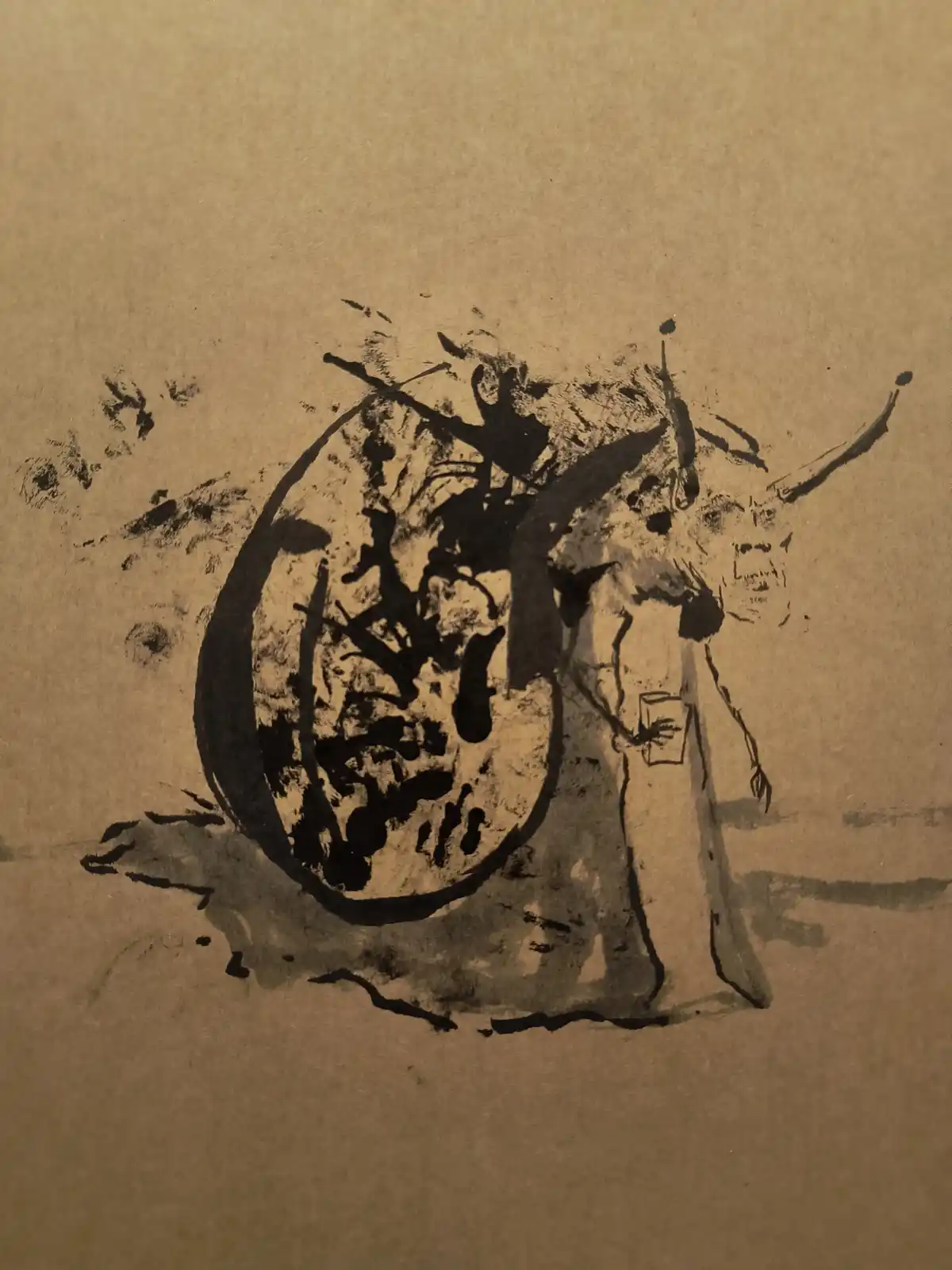 A crude black ink drawing on brown paper depicts a humanoid figure with a large, detailed snail shell on its back…