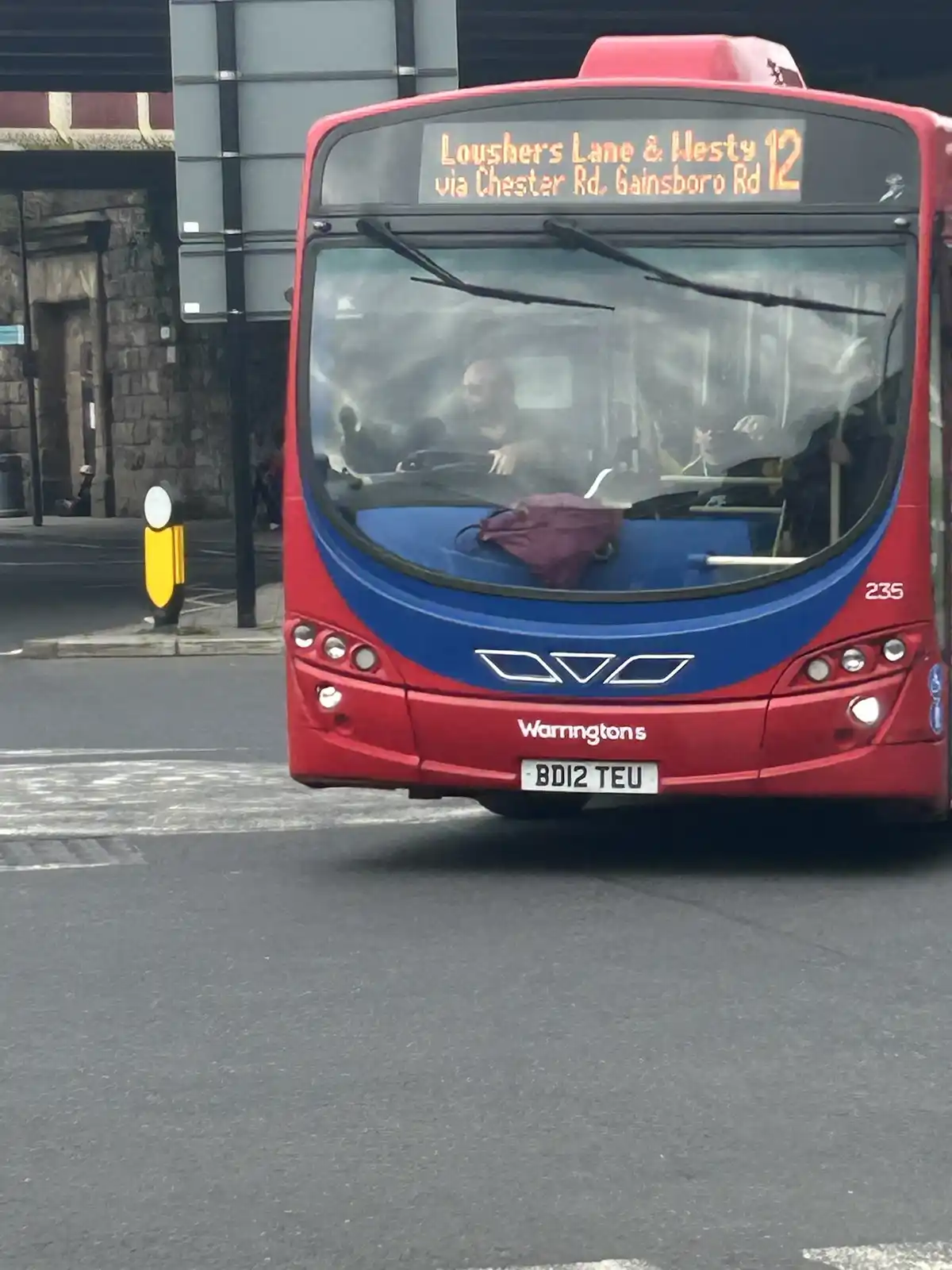 A red and blue bus with the route displayed as 'Lousher's Lane & Westy 12 via Chester Rd, Gainsboro Rd' on its electronic…