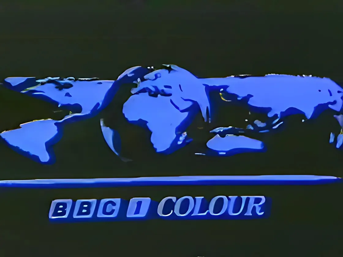 A vintage BBC 1 Colour television ident featuring a glowing blue world map silhouette against a dark background, with the…