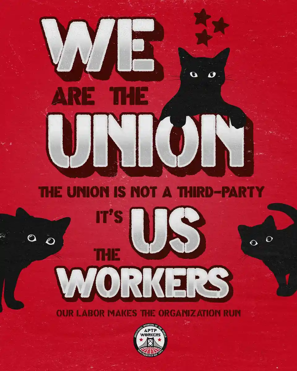 A red poster features three black cats and bold white text declaring 'WE ARE THE UNION' and 'IT'S US THE WORKERS'. The text…