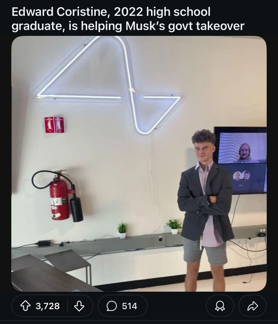 A young man in a blazer and shorts stands confidently with arms crossed in a modern office space. Behind him is a large neon…