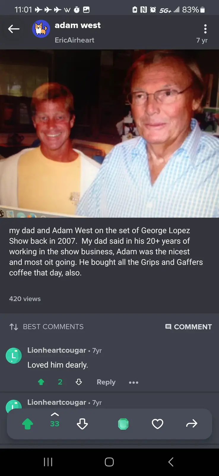 A photo shows two men posing together, one in a yellow shirt smiling broadly, the other in a blue checkered shirt with…