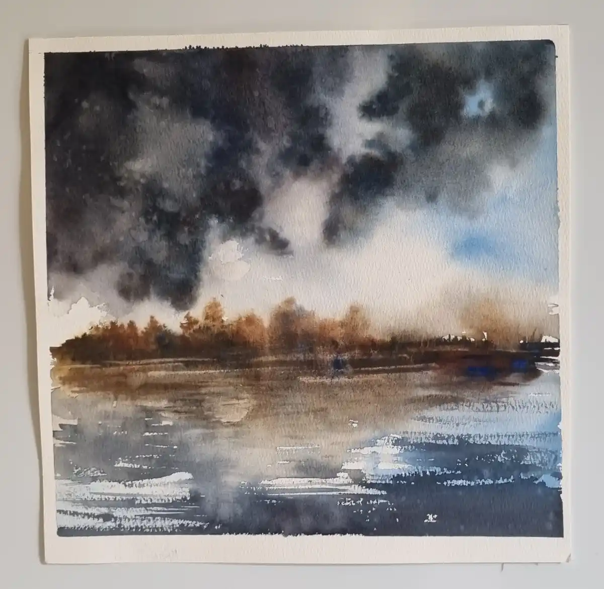A watercolor painting depicts a moody landscape with dark, stormy clouds above a reflective body of water and distant trees…