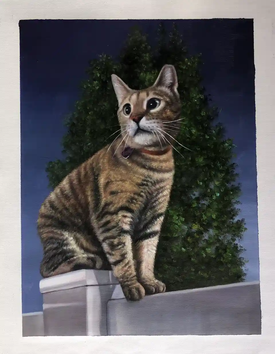 A realistic painting of a tabby cat sitting on a white fence post against a dark blue sky with green bushes behind it…