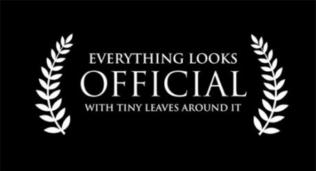 A black background with white text and laurel wreath graphics. The text reads 'EVERYTHING LOOKS OFFICIAL WITH TINY LEAVES…