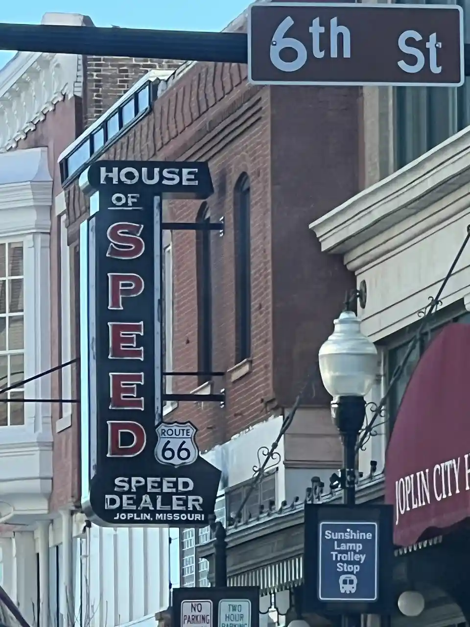A street view shows a vintage black sign reading 'HOUSE OF SPEED' with 'SPEED DEALER JOPLIN, MISSOURI' and a Route 66 shield…