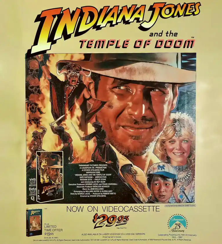 This is a vintage VHS advertisement poster for the 1984 film 'Indiana Jones and the Temple of Doom,' featuring a large…
