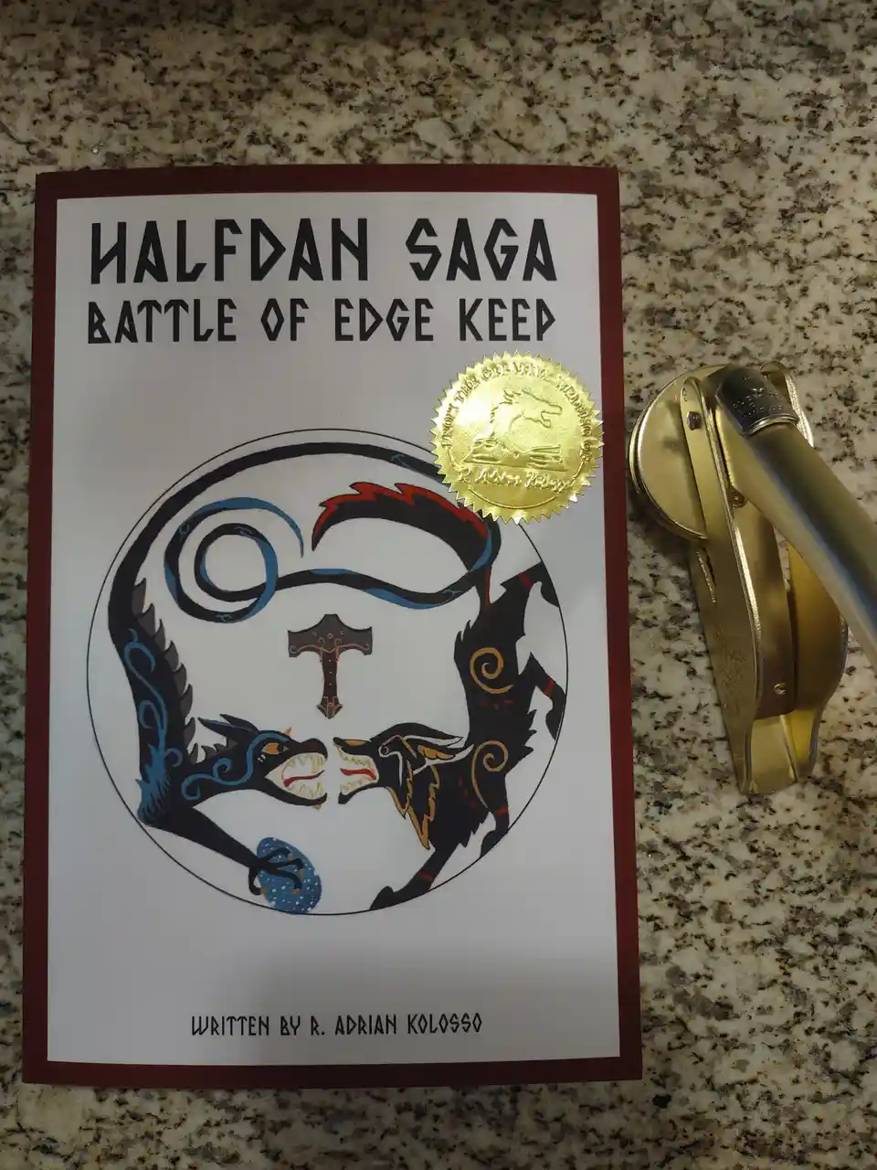 A book cover titled 'HALFDAN SAGA BATTLE OF EDGE KEEP' by R. Adrian Kolosso, featuring a circular illustration of two…