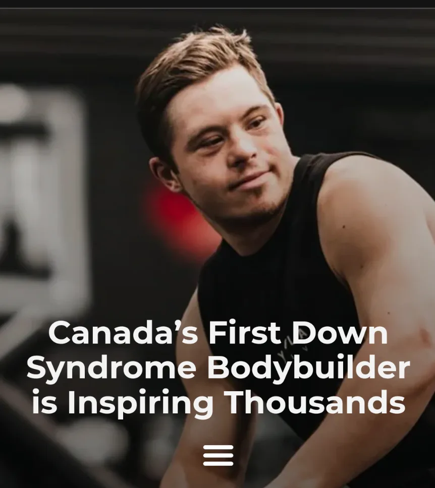 A muscular man with Down syndrome, wearing a black tank top, smiles confidently in a gym setting. The overlaid white text…