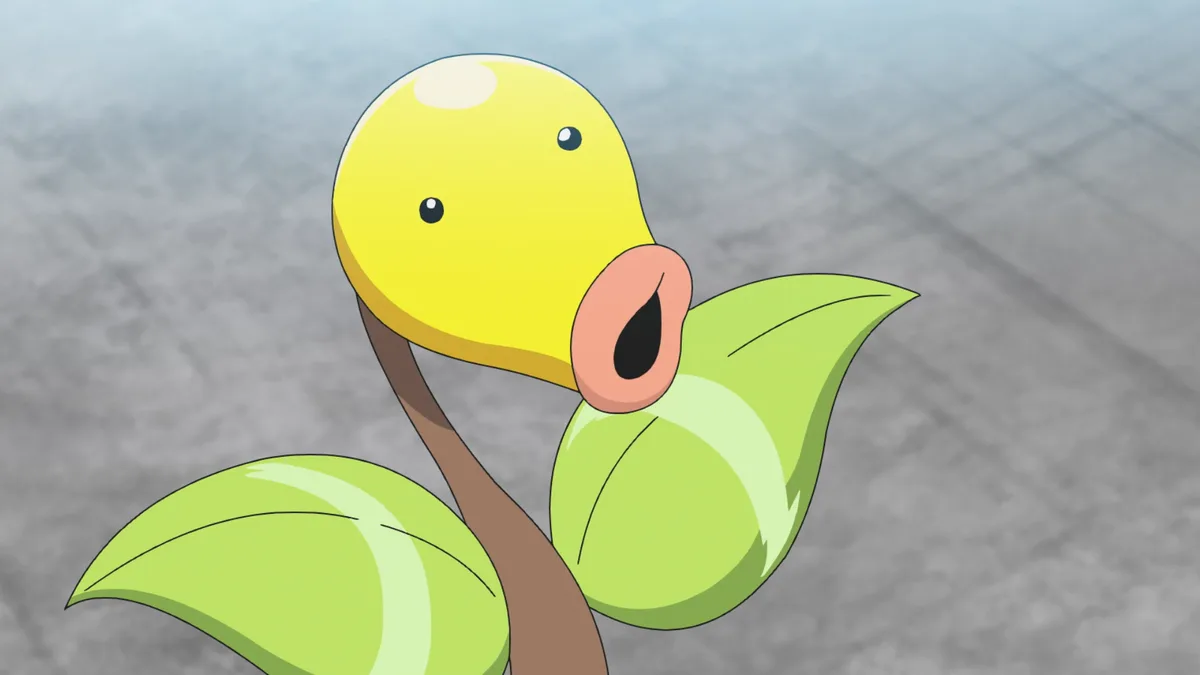 A close-up of the Pokémon Bellsprout, a yellow bulb-headed creature with green leaves for arms and a brown stem, looking…