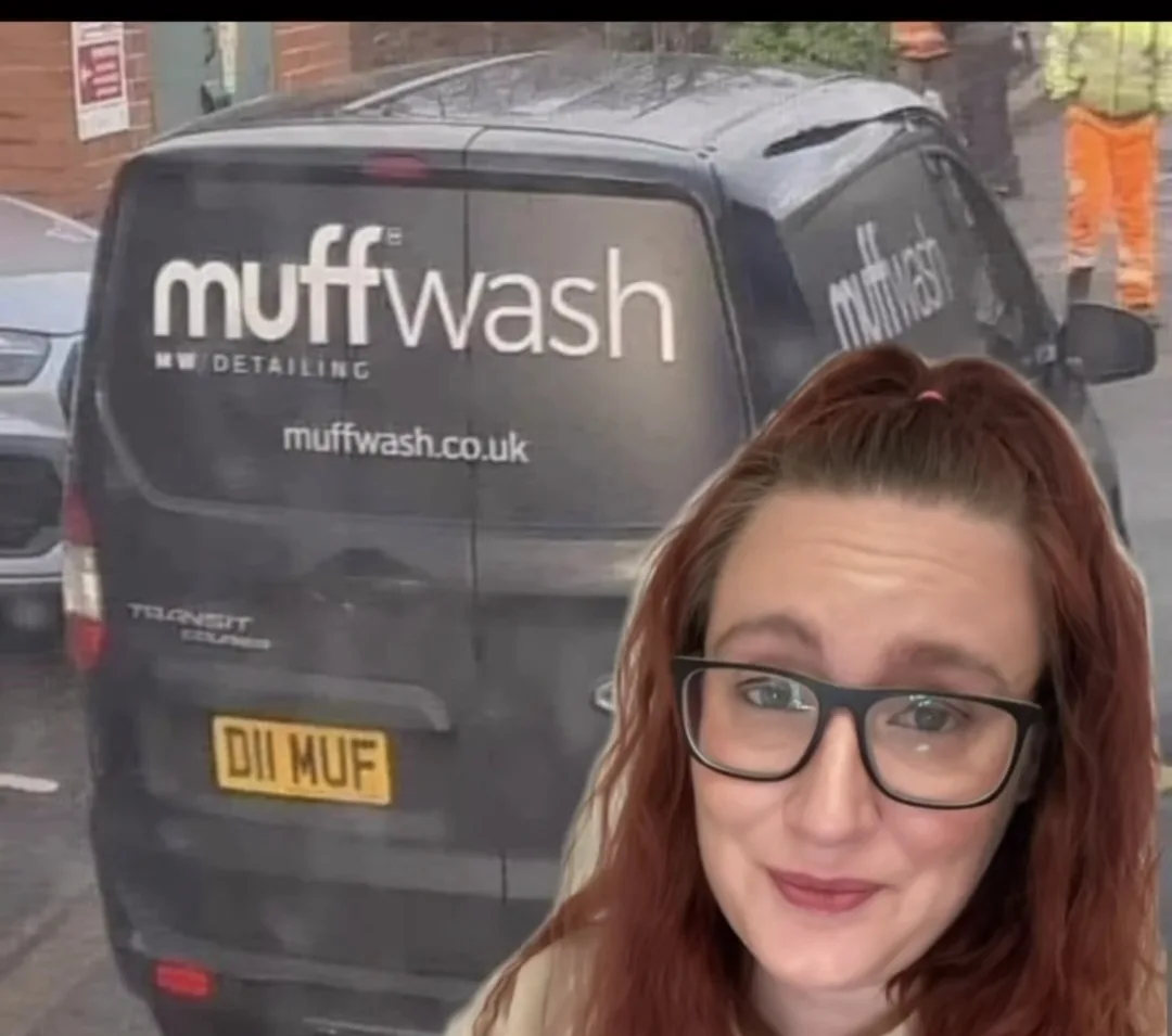 A woman with red hair and glasses is superimposed in front of a black Ford Transit van. The van has 'muffwash' and 'MW…