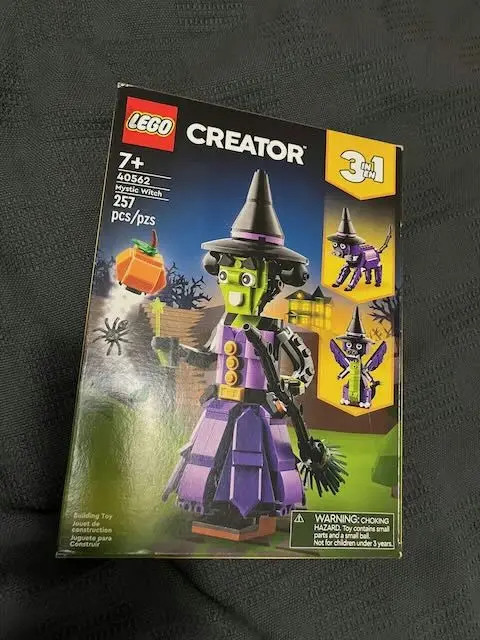 A LEGO Creator 3-in-1 set box (40552 Mystic Witch) showing a large purple witch with a black hat and broom, alongside…