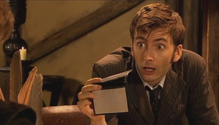 a man in a pinstripe suit holds a blank card with a shocked, wide-eyed expression. The overlaid text reads 'i've got a…