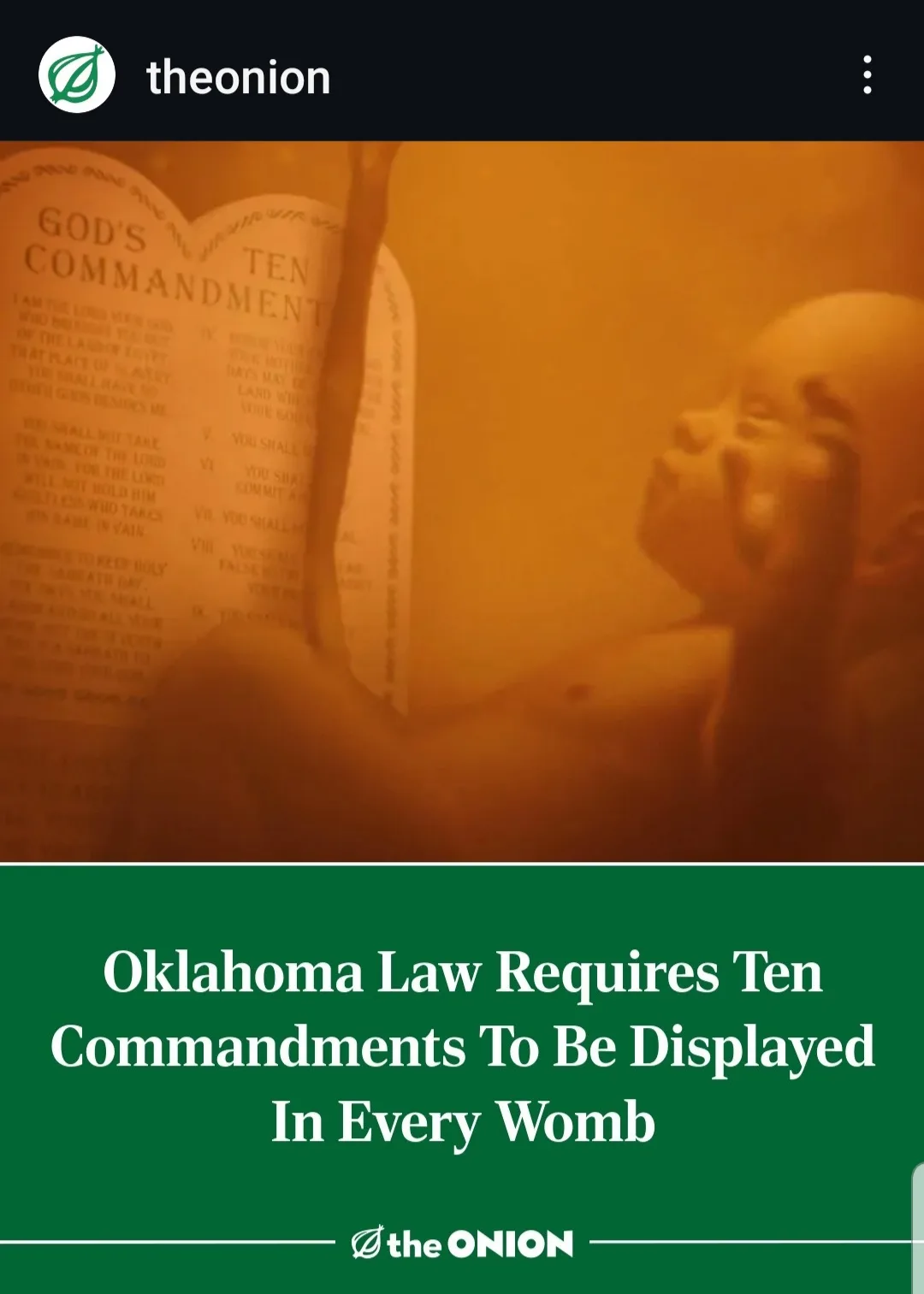 A blurry, orange-tinted image shows a baby in a womb-like environment, looking up at two stone tablets labeled 'GOD'S…