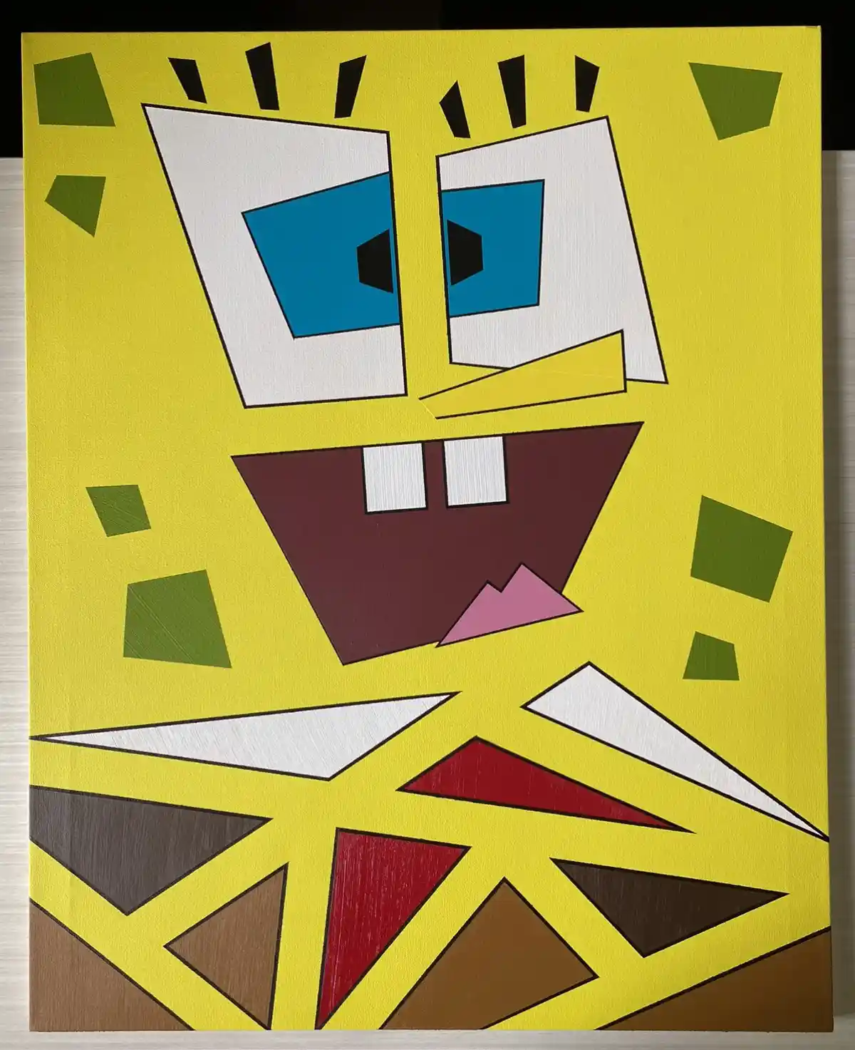 A painting of SpongeBob SquarePants' face rendered in a geometric, abstract style with sharp angles and fragmented shapes…