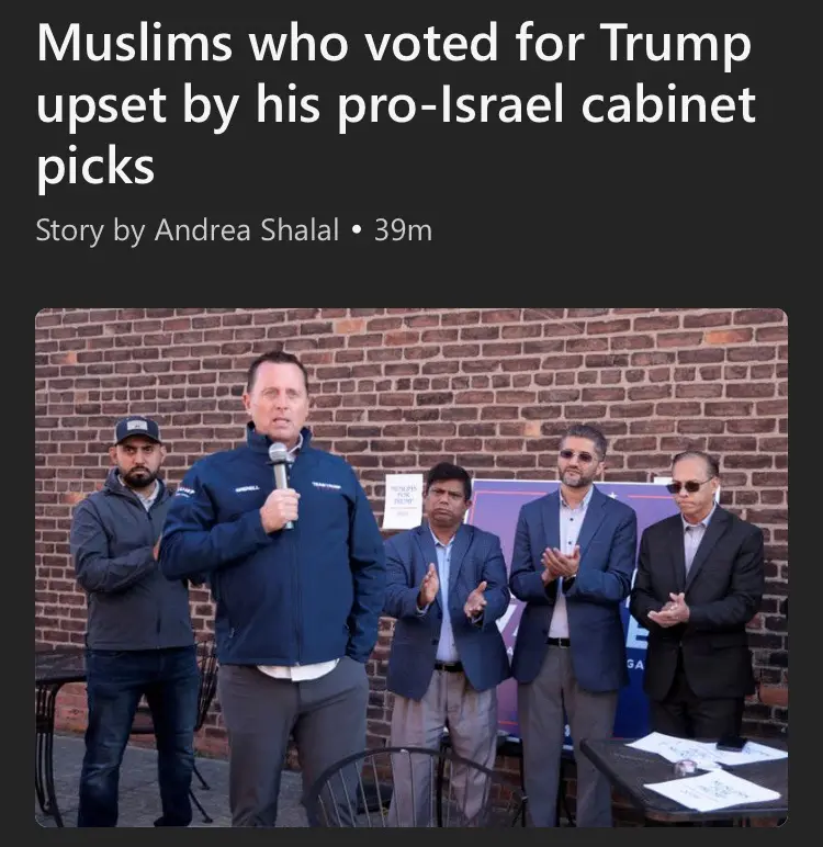 A screenshot of a news article header showing a photo of five men standing in front of a brick wall. A man in a blue jacket…