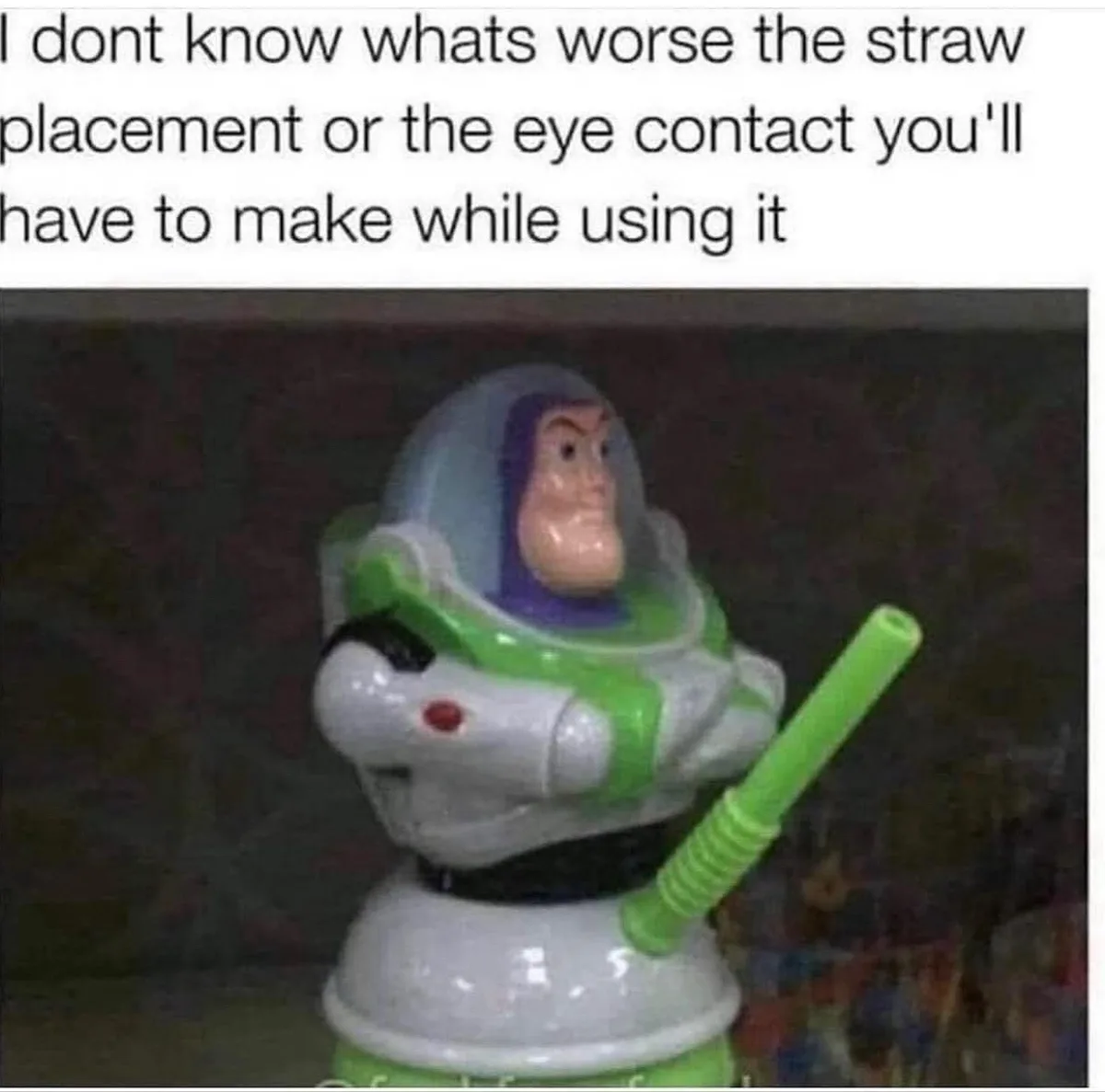 A small Buzz Lightyear toy figure is shown with a green plastic straw inserted into its mouth, forcing it to look directly…
