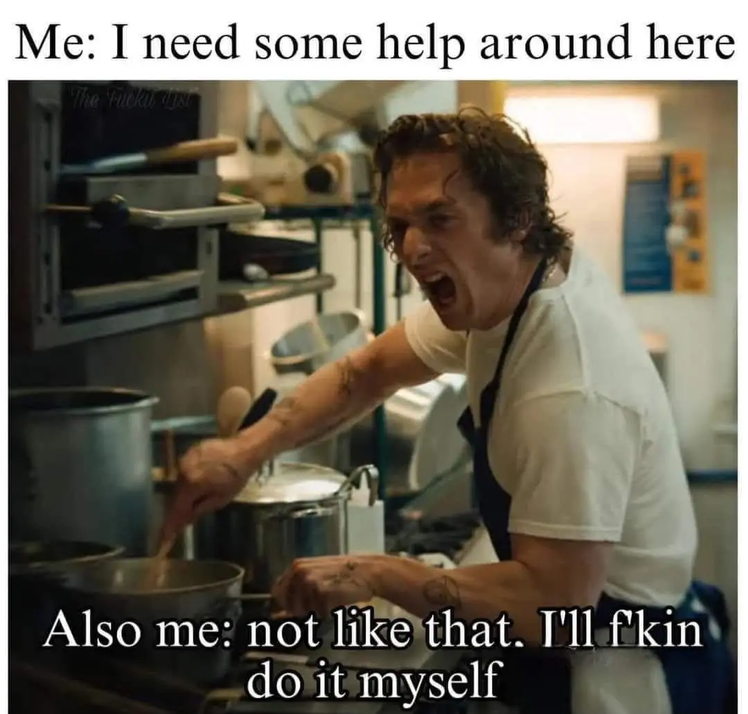 A man in a white t-shirt and black apron is yelling in a commercial kitchen while stirring a pot. The text at the top reads…