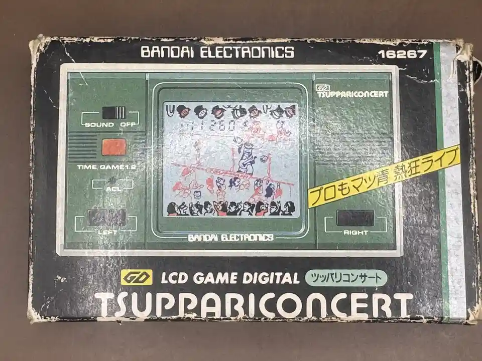 A weathered, vintage Bandai Electronics LCD game box for 'Tsuppari Concert' (ツッパリコンサート), showing a pixelated concert scene…