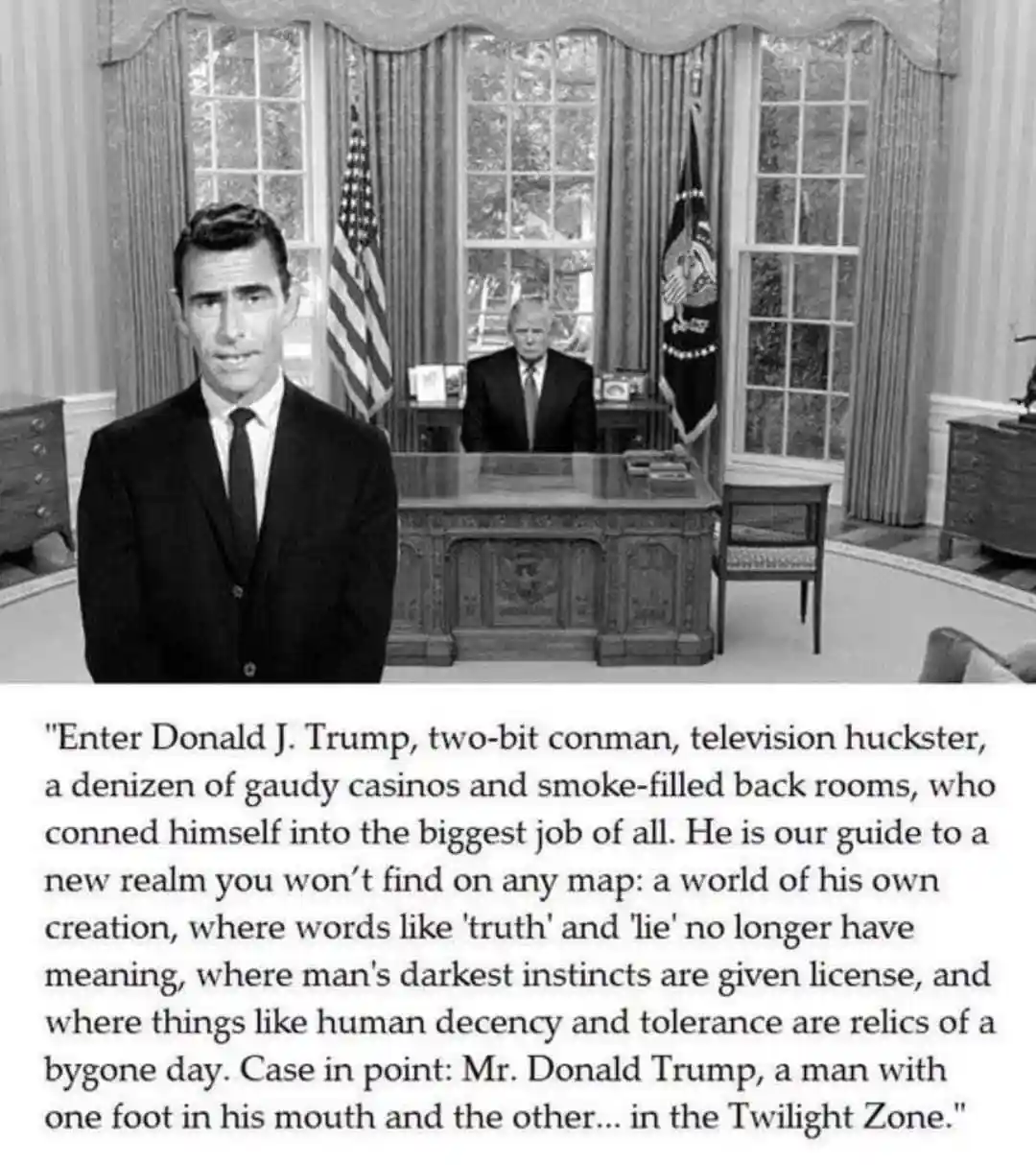 A black-and-white photo shows a man in a suit standing in front of a desk, with another man seated behind the desk. The…