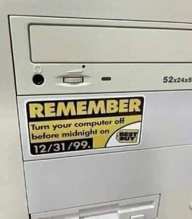 A close-up of a beige computer drive bay with a yellow and black sticker that reads 'REMEMBER Turn your computer off before…