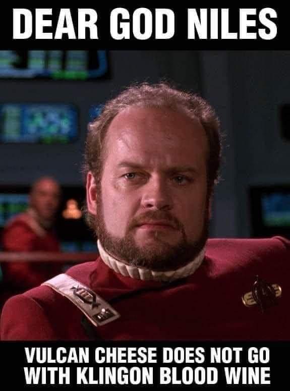 A man in a red Starfleet uniform with a stern, exasperated expression looks directly at the camera. The image has white text…