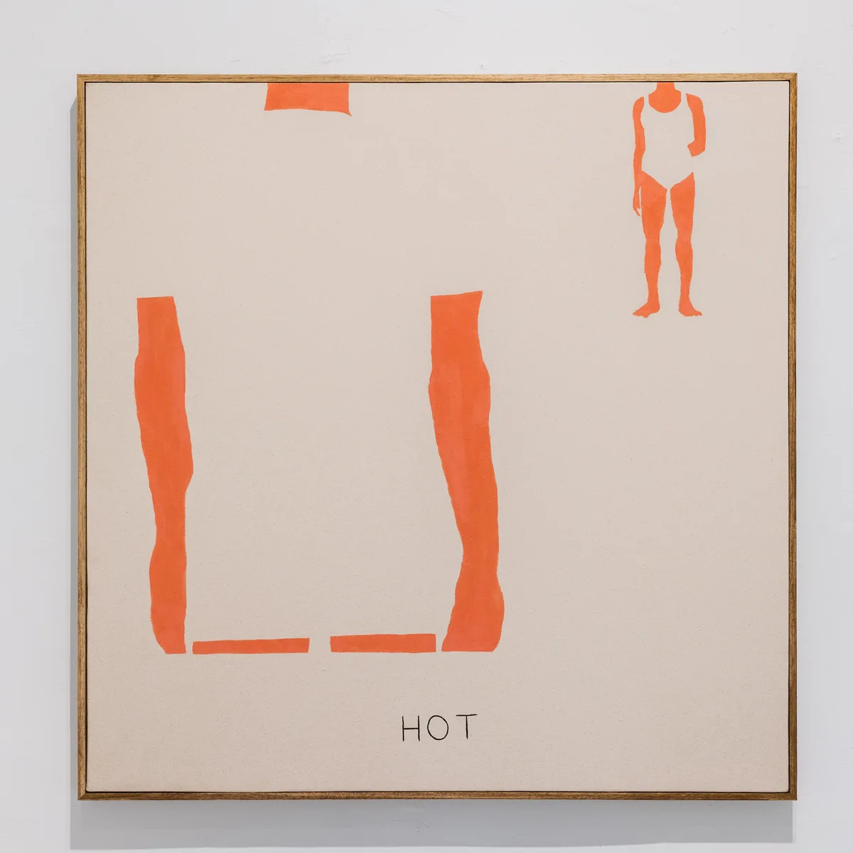 A framed abstract painting on beige canvas shows orange shapes: two vertical forms resembling legs and feet, a small…