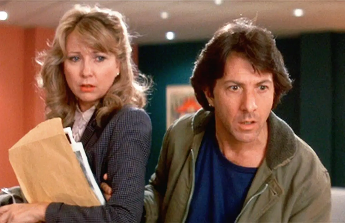 A still from the 1980s film 'The Blues Brothers' shows two characters, a woman holding a brown paper folder and a man in a…