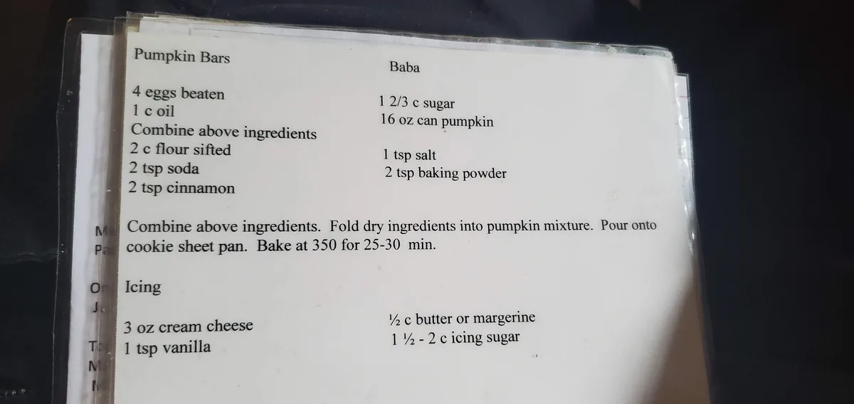 A printed recipe card for 'Pumpkin Bars' and 'Baba' is shown, listing ingredients like eggs, oil, flour, sugar, pumpkin, and…