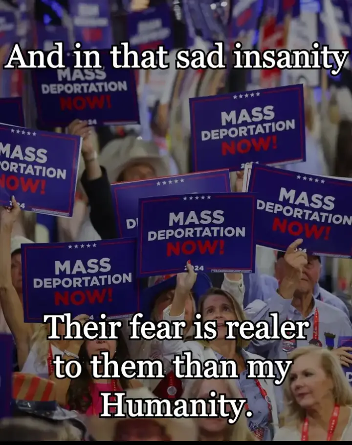 A crowd of people at what appears to be a political rally, holding up multiple identical blue signs that read 'MASS…