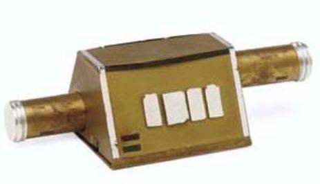 A brass-colored mechanical component with two cylindrical ports and a rectangular body, featuring three white rectangular…