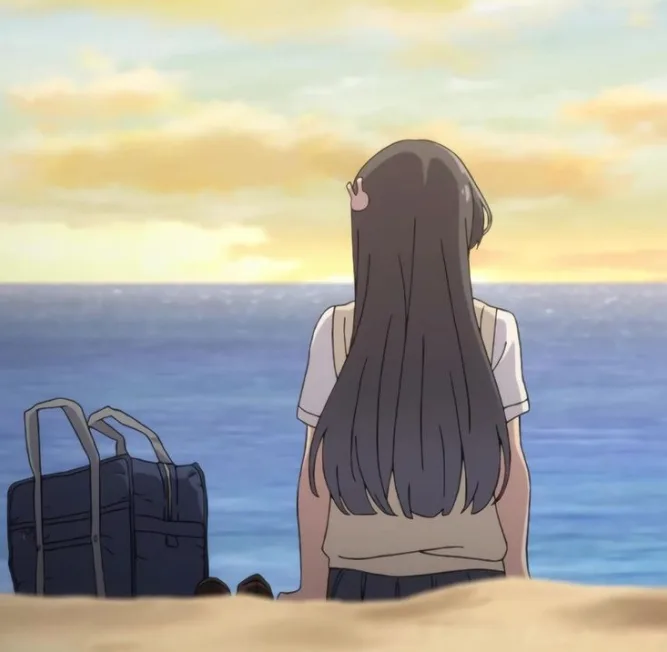 An anime girl with long dark hair sits on a beach facing the ocean at sunset, her back to the viewer, with a dark backpack…