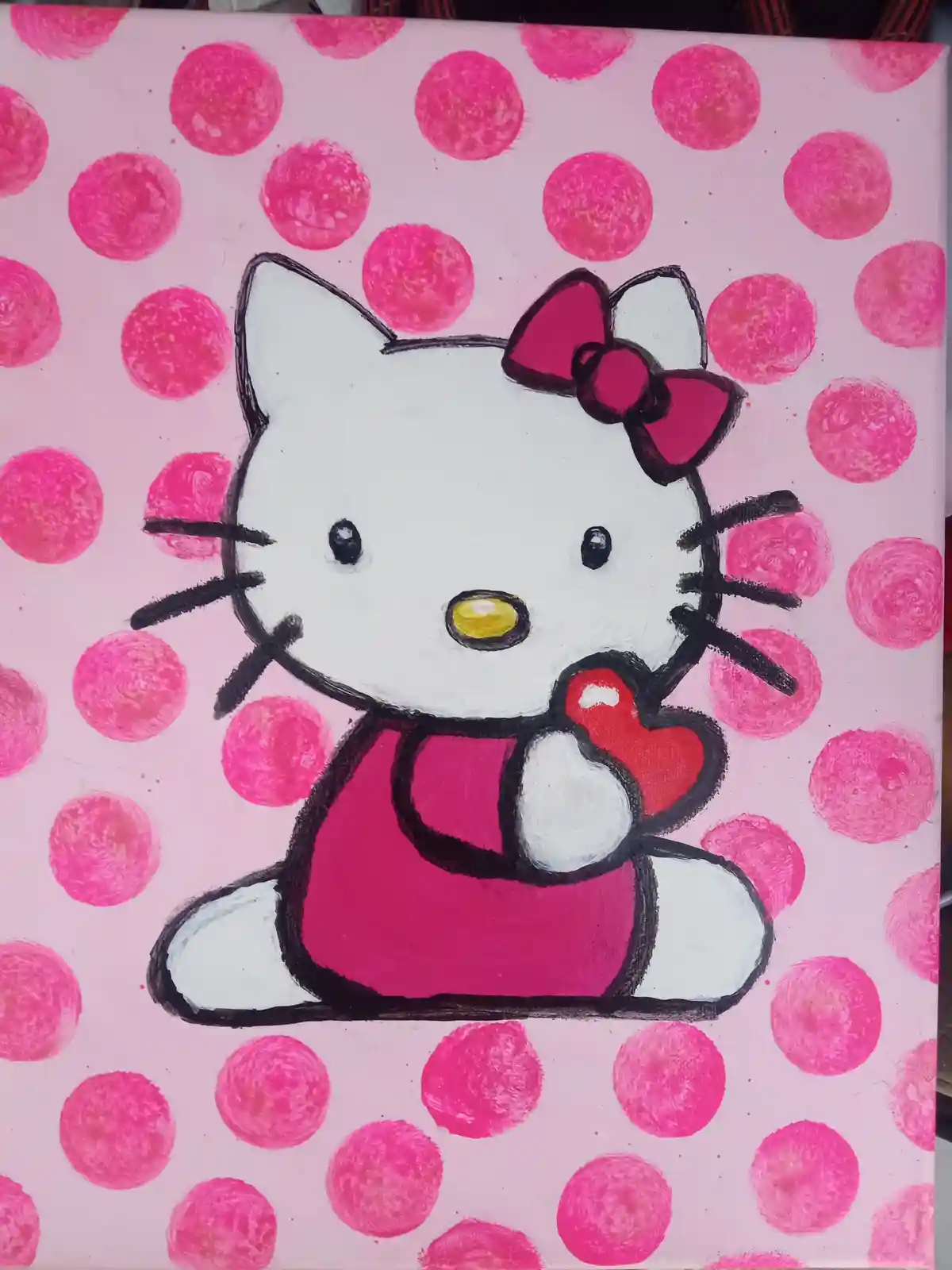 A hand-painted canvas depicts the cartoon character Hello Kitty, drawn in black outlines with white fur, wearing a pink bow…