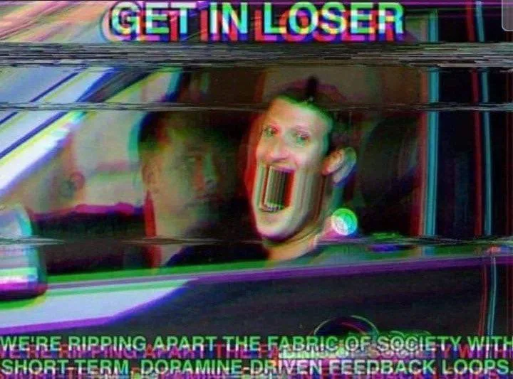 A distorted, glitchy image shows a man in a car with his mouth stretched open unnaturally, overlaid with bold, colorful text…