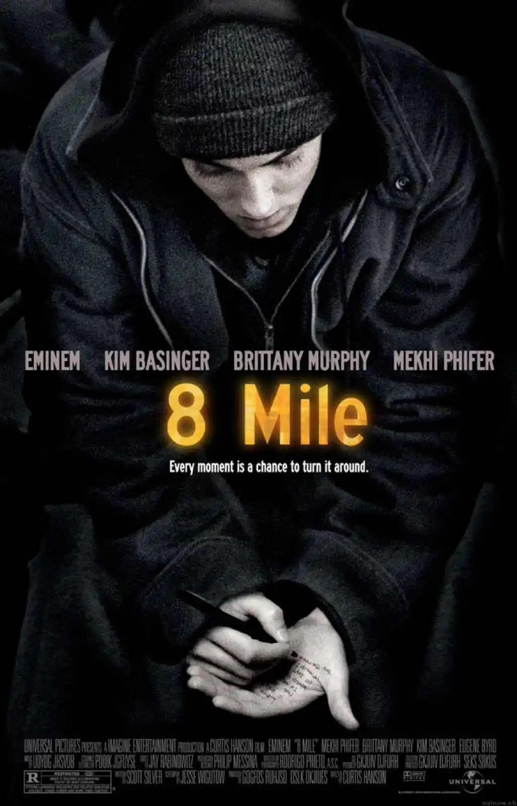 A black-and-white movie poster for '8 Mile' featuring Eminem in a dark hoodie and beanie, looking down while writing on his…
