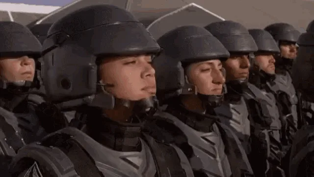A GIF showing a soldier in a helmet and uniform, initially looking stoic, then progressively becoming more animated and…