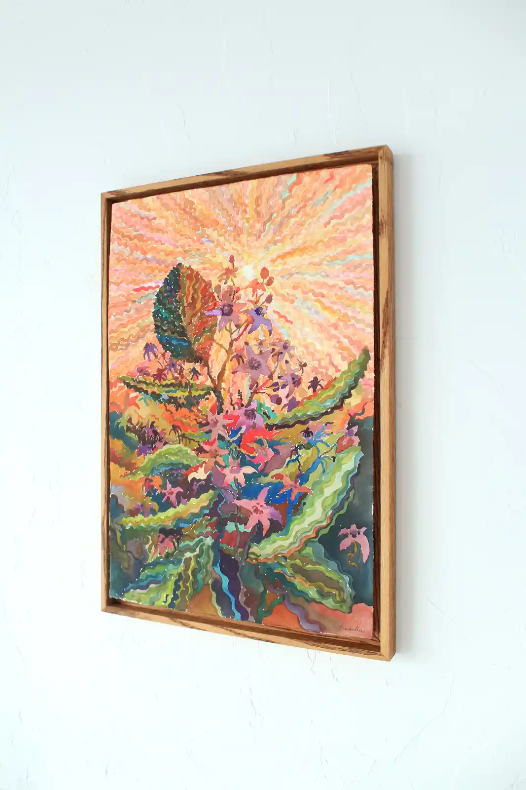 A framed watercolor painting hangs on a white wall, depicting a vibrant, abstract landscape with wavy, colorful brushstrokes…