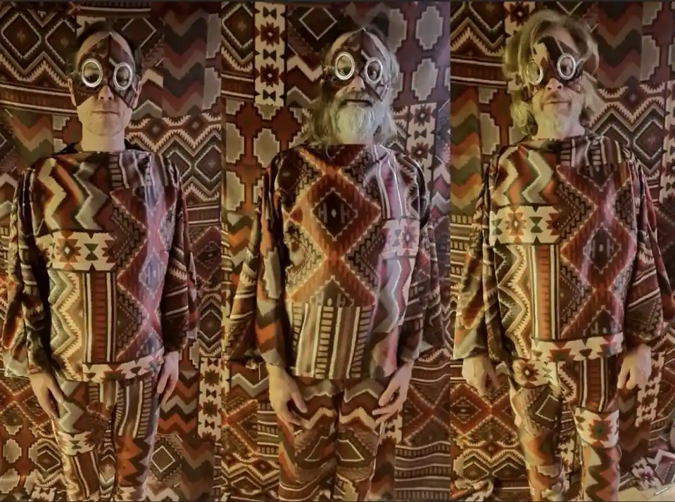 Three side-by-side photos show the same man in a full-body, patterned outfit with a matching mask covering his eyes…