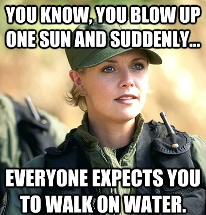 A woman in military-style gear with a cap and vest looks off to the side with a knowing, slightly exasperated expression…