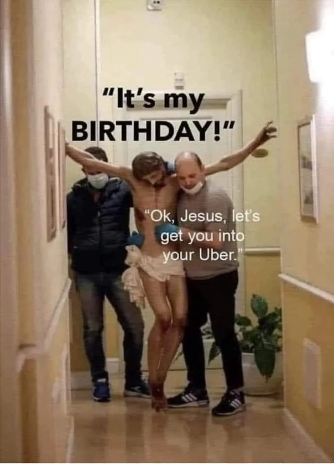 Two men in masks carry a shirtless man dressed as Jesus through a hallway, with text overlaid saying 'It's my BIRTHDAY!' and…