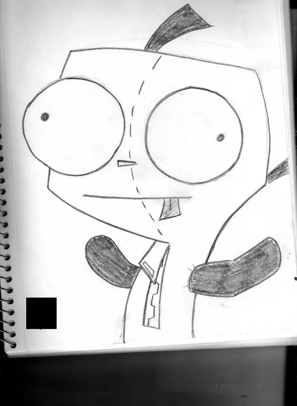 A hand-drawn pencil sketch on notebook paper shows a cartoon character with a square head, large round eyes, and a small…