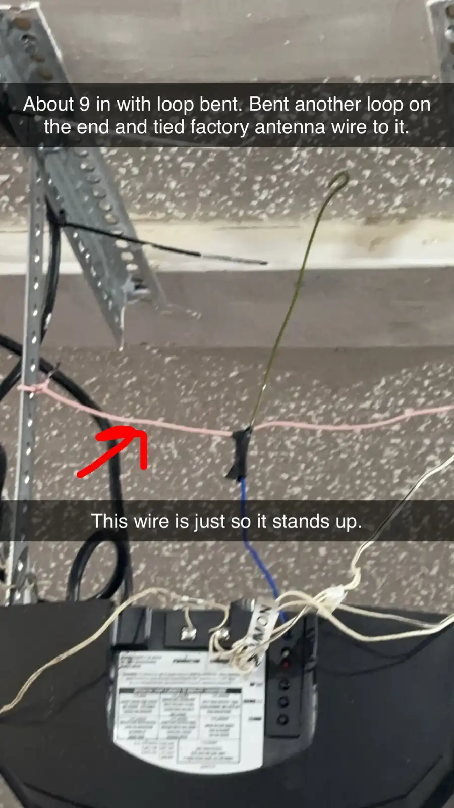 A close-up photo shows a makeshift antenna setup inside a vehicle, featuring a bent green wire tied to a pink string for…