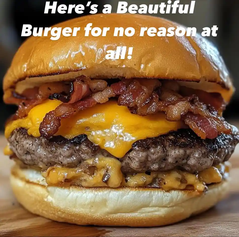 A close-up photo of a large, appetizing cheeseburger with crispy bacon, melted cheese, and a grilled patty between two buns…