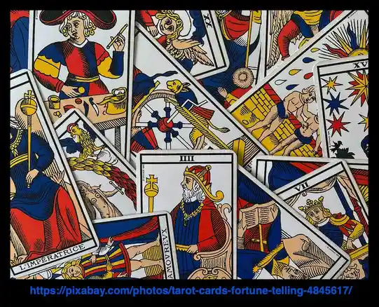 A scattered pile of colorful, vintage-style tarot cards featuring illustrated figures like 'L'IMPERATRICE' and 'L'AMOUREUX'…