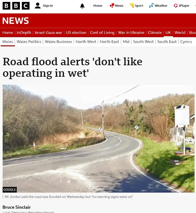 A screenshot of a BBC News article shows a dry, curving rural road with trees and grass on either side. The headline reads…