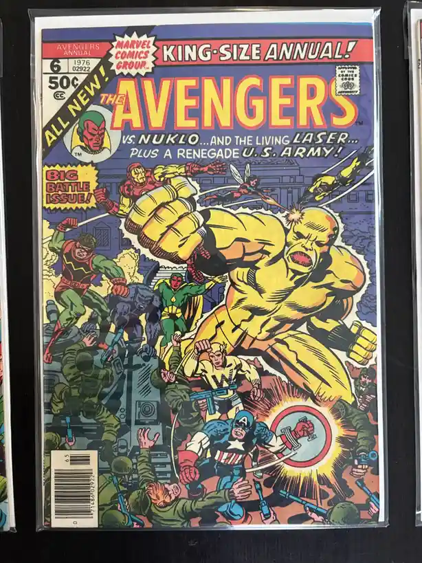 The image shows the cover of a 1976 Marvel Comics Group 'Avengers Annual #6' comic book, featuring a dynamic battle scene…