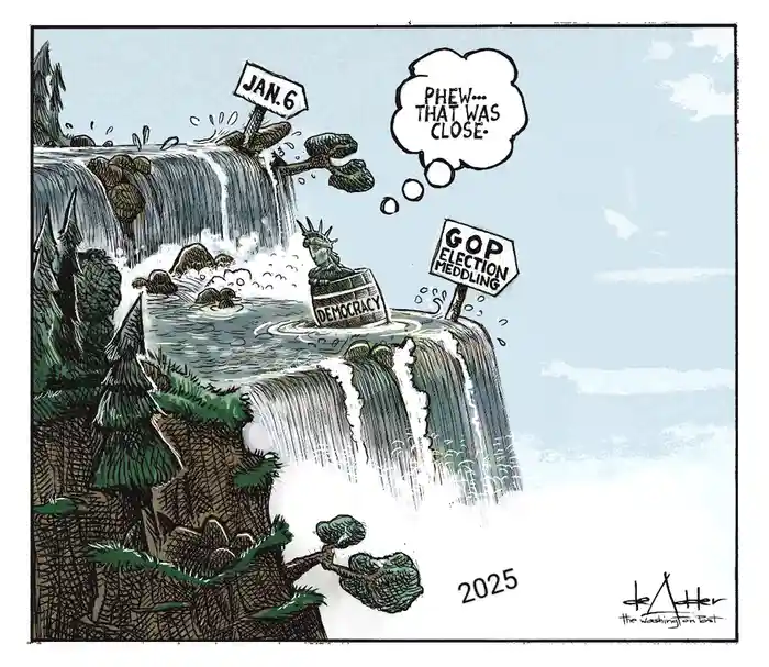 A cartoon depicts the Statue of Liberty, labeled 'DEMOCRACY', floating in a river between two waterfalls. One waterfall is…